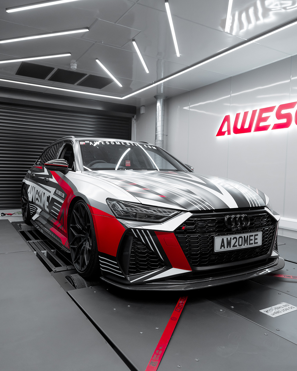 Awesome's Manchester workshop floor with a VW Audi Group car on the ramp