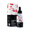 A product image of Tinyroots Japanese Choji Oil, a rust prevention solution specifically designed for the maintenance of bonsai tools. The image features the product's packaging: a rectangular cardboard box and a clear 1 fluid ounce (30ml) glass bottle equipped with a black rubber-topped glass dropper. 

The packaging design is split horizontally into two sections. The top half is white, decorated with an elegant pattern of red and white cherry blossoms (sakura) and subtle grey geometric shapes. The brand name "Tinyroots" is printed vertically in black, alongside a small red square containing the Japanese kanji for oil (油). 

The bottom half of both the box and the bottle label is solid black with bold white lettering. The text on the front of the box reads "CHOJI OIL," "RUST PREVENTION SOLUTION," and "1 FL.OZ (30ML)." The side of the box lists key product benefits such as "EASY TO USE DISPENSER," "PROTECTS & PRESERVES TOOLS," and "PREVENTS OXIDATION & RUST." It also notes that this is part of a "3-PIECE KIT" including Choji oil, a rust eraser, and a lint-free cloth. Small icons indicate the product is "READY TO USE!" and comes with a "100% SATISFACTION GUARANTEED" seal. The glass bottle's label mirrors this design, with a large, faint grey kanji character for oil in the background of the black section.