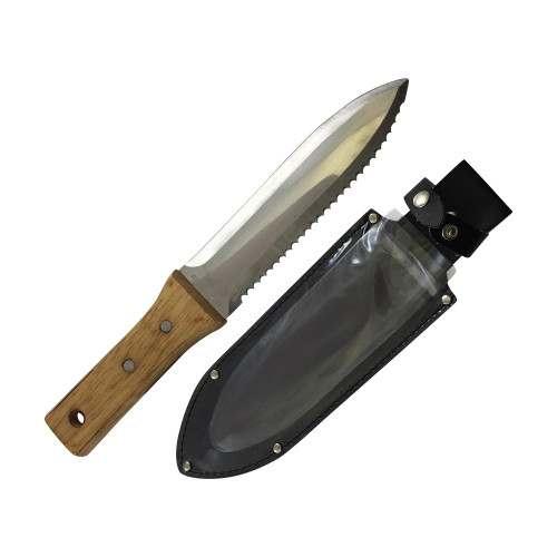 A Tinyroots Hori Hori all-purpose soil knife and its matching black sheath are displayed against a clean white background. The multi-purpose gardening tool features a polished stainless steel blade with a sharp point, a smooth cutting edge on one side, and a serrated edge on the other for sawing through tough roots. The words "STAINLESS STEEL" are etched near the hilt. Its handle is made from a light-colored hardwood, secured with two metal rivets and finished with a hole for a lanyard. The protective sheath is constructed from black material with a clear plastic front, reinforced with silver rivets, and includes a belt loop and a snap-button closure strap to secure the knife.