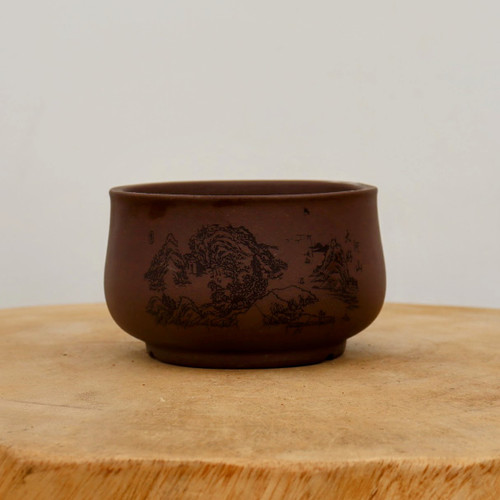 4 inch round etched Yixing bonsai pot in dark brown with a landscape etching