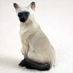 Miniature Siamese cat figurine with a cream body and dark points, seated
