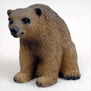 Miniature brown bear figurine sitting upright, a decorative bonsai accessory