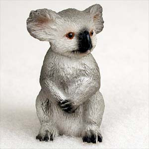 Miniature koala figurine sitting upright with its front paws tucked, a bonsai accessory