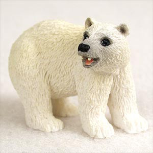 A detailed miniature polar bear bonsai tree figurine stands alert on all fours against a plain white background. The figurine is crafted with a highly textured surface to mimic the thick, white fur of a real polar bear. It features realistic details, including dark, glossy eyes, a black nose, and a slightly open mouth that reveals a hint of pink inside. Positioned as if looking off to the side, this small decorative accessory is designed to be placed within a bonsai tree landscape to add character and a sense of scale, helping to create a themed arctic or winter scene.