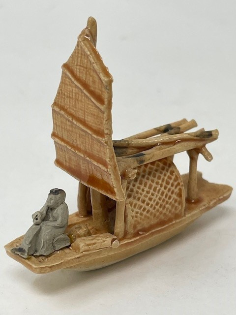 Glazed Chinese mudman figurine of a traditional junk boat with a ribbed sail