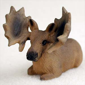 Miniature bull moose figurine resting with its legs tucked, a bonsai accessory