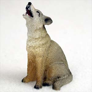 Miniature coyote figurine sitting and howling, a decorative bonsai accessory