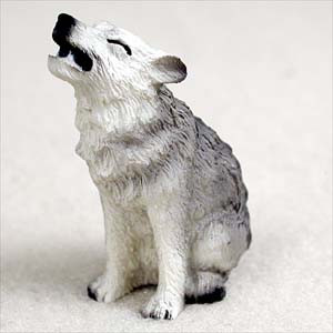 Miniature gray wolf figurine sitting and howling, a decorative bonsai accessory