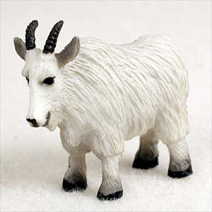 Miniature white mountain goat figurine with a thick shaggy coat
