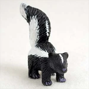 Miniature black and white skunk figurine, a decorative bonsai accessory