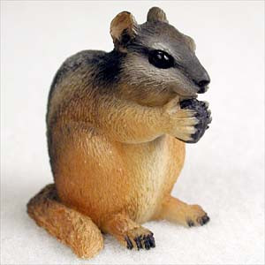A highly detailed chipmunk bonsai tree figurine, captured in a realistic sitting pose against a plain white background. This miniature animal ornament features intricate molded textures mimicking soft fur, with a warm tan belly and lower face contrasting against a darker gray and brown striped back and head. The chipmunk is depicted with its front paws raised, holding a small, dark-colored nut or acorn to its mouth as if feeding. It has large, glossy black eyes and small, dark-tipped claws on its paws and feet. This small garden accessory is designed to add a lifelike touch of nature and a sense of scale to bonsai tree displays, fairy gardens, or miniature landscapes.
