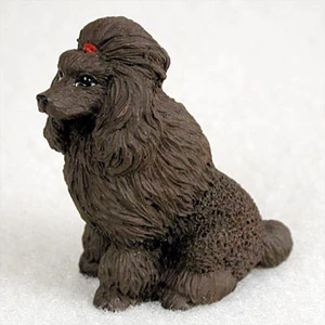 Miniature chocolate brown poodle figurine seated, with a long curly coat