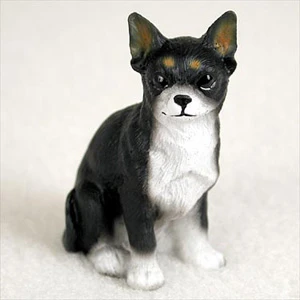 Miniature black and white Chihuahua figurine seated and facing forward