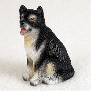Miniature Alaskan Malamute figurine sitting upright, hand painted