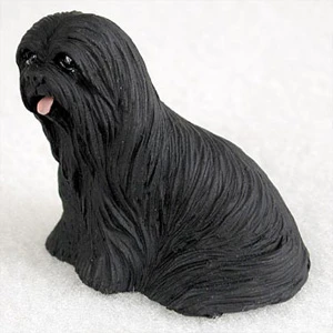 Miniature black Lhasa Apso figurine seated and facing slightly left