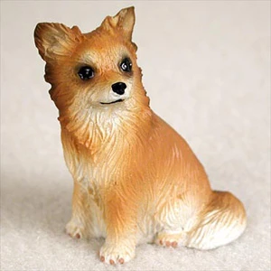 Miniature longhaired tan and white Chihuahua figurine in a seated pose