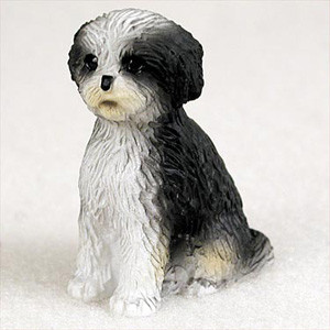 Miniature black and white Shih Tzu figurine with a sport cut, in a classic seated pose