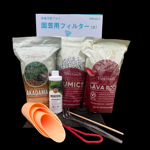 A comprehensive bonsai repotting survival kit from Bonsai Outlet is displayed against a solid black background. In the back, a white box for a Minex "Garden Filter" (large soil sieve) features blue Japanese characters. 

The foreground is filled with professional-grade repotting supplies. Three large bags of Tinyroots brand soil components stand side-by-side: Akadama in a tan bag, Horticulture Pumice in a grey bag, and red Lava Rock in a burgundy bag. Each bag is labeled as a "Premium Soil Additive" or "Aggregate."

Centered in front of the bags is an 8 fl oz white plastic bottle of Tinyroots MicroTotal premium micronutrient supplement. To the left are three nested orange plastic soil scoops of varying sizes. Arrayed in front are several essential bonsai tools: a pair of red-handled pruning shears, long stainless steel tweezers, a metal hand rake with three tines, a wooden chopstick for soil aeration, a piece of black plastic drainage mesh, and a small coil of black bonsai training wire. The collection provides all the necessary elements for successfully repotting and maintaining healthy bonsai trees.