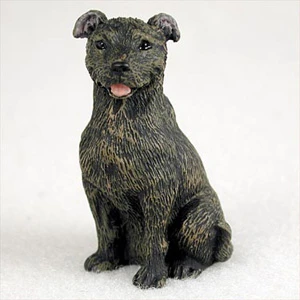 Miniature brindle Staffordshire Bull Terrier figurine seated alert