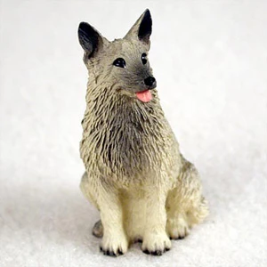 Miniature Norwegian Elkhound figurine in a sitting position, looking alert