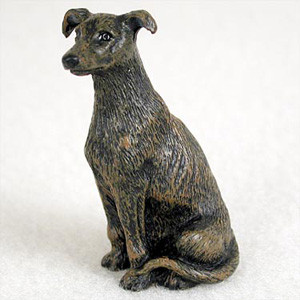 Miniature brindle Greyhound figurine in a sitting position, textured coat
