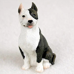 Miniature brindle and white Pit Bull Terrier figurine with a split color face
