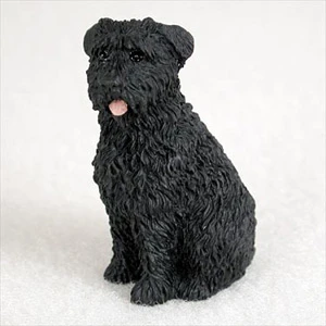 Miniature black Bouvier des Flandres figurine in a sturdy upright sitting position