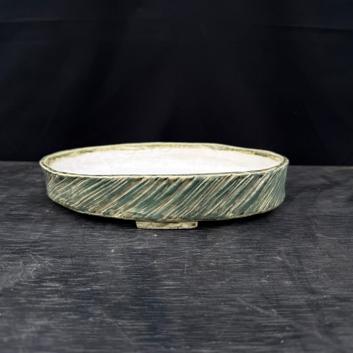 10 inch oval John Fazzino bonsai pot in a deep green glaze with diagonal carving