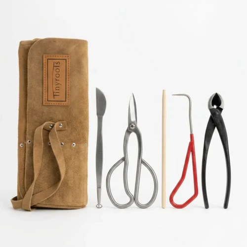 Tinyroots six piece beginner bonsai tool kit with a rolled tan suede tool roll