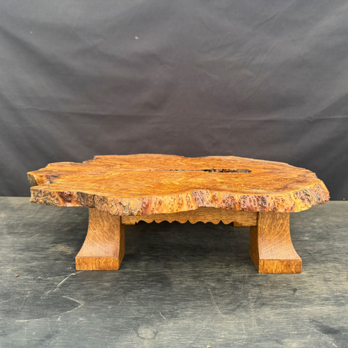 Front view of the low Bio-Morph bonsai display stand with an irregular olivewood burl top, natural live edge and four flared quartersawn white oak legs.