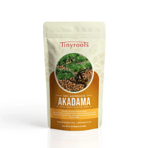 A product shot of a 2.25-quart (2.48L) bag of Tinyroots Akadama Soil Aggregate, a premium hard bonsai soil. The cream-colored, resealable stand-up pouch features the red "Tinyroots" logo at the top and a circular central image showing a healthy green conifer bonsai tree planted in the granular, reddish-brown Akadama soil. 

Bold white text on a large brown banner identifies the product as "SOIL AGGREGATE AKADAMA" and highlights its primary benefit to "aid and promote healthy root growth." The packaging specifies that the contents are 100% double-sifted hard Akadama, making it premixed and ready to use without dust. It emphasizes the soil's popularity for both conifers and deciduous trees due to its superior ability to retain water and nutrients while providing the essential porosity and free drainage required for professional bonsai care. The bag is shown upright on a white, reflective surface, highlighting its professional branding.