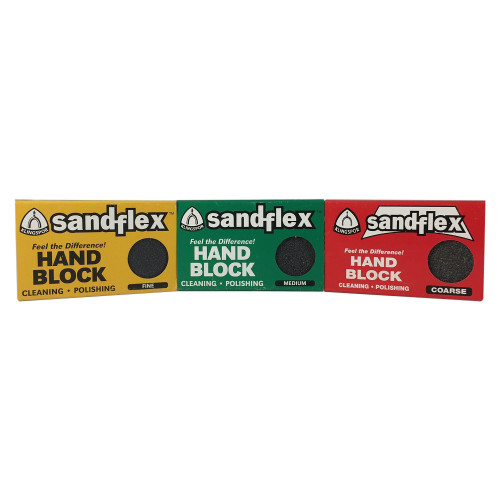 A photo showcasing three Klingspor Sandflex Hand Blocks for cleaning and polishing, arranged side-by-side against a plain white background. 

From left to right, the rectangular boxes are color-coded by their grit level:
*   The first box on the left is bright yellow, indicating a **FINE** grit. It features the "sandflex" brand name in bold blue and white lettering, the Klingspor logo, and the text "Feel the Difference! HAND BLOCK CLEANING • POLISHING." A circular cutout reveals a smooth, dark gray abrasive block inside.
*   The center box is green, representing a **MEDIUM** grit. The layout is identical to the first, but with white text for "HAND BLOCK." The visible abrasive material in the circular window has a slightly more textured appearance than the fine block.
*   The final box on the right is a vibrant red for **COARSE** grit. Similar in design to the others, the circular cutout shows a noticeably rougher, pebbly dark gray texture. 

These flexible abrasive blocks are essential tools for maintaining metal equipment, frequently used to remove rust, sap, and stains from high-quality bonsai shears and other gardening tools without damaging the underlying metal.