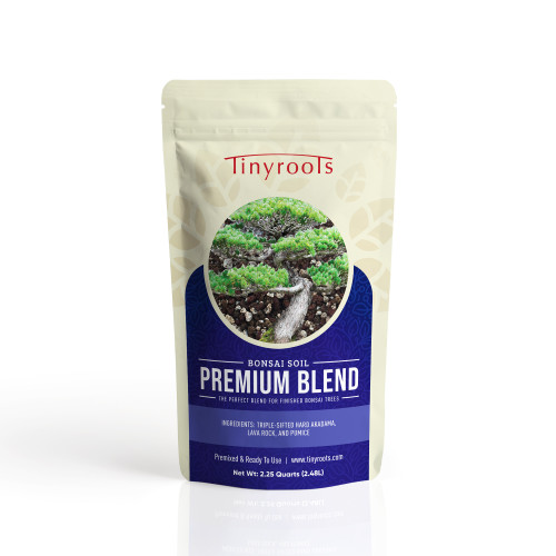 A product shot of a 2.25-quart resealable pouch of Tinyroots Premium Blend Bonsai Soil. The cream-colored bag features the red Tinyroots logo at the top and a prominent circular image showcasing a mature, healthy pine bonsai tree growing in a coarse, gritty substrate. Below the image, bold white text on a deep blue decorative background identifies the product as "PREMIUM BLEND BONSAI SOIL," specifically described as "the perfect blend for finished bonsai trees." The ingredients are clearly listed on the front as triple-sifted hard akadama, lava rock, and pumice. Additional text at the bottom indicates the soil is "Premixed & Ready To Use," includes the brand's website, and specifies the net volume as 2.25 Quarts (2.48L).