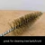 Close-up of the brass colored wire bristles on the steel bonsai brush