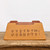 Underside of the rectangular unglazed bonsai pot on weathered wood
