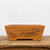 Unglazed terracotta bonsai pot on a weathered wooden tabletop