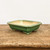 Rectangular green glazed bonsai pot on a weathered wooden surface