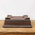 Underside of the unglazed dark brown rectangular bonsai pot