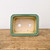 High angle straight-on view of the green glazed rectangular bonsai pot