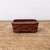Unglazed Bigei Tokoname bonsai pot on a weathered wooden surface