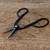 Kaneshin 36B bonsai shears resting open on a weathered light brown surface