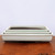 Three nested cream glazed bonsai pots on a warm-toned wooden surface