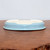 Underside of the shallow oval light blue glazed bonsai pot