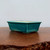 Side view of the rectangular pot in a vibrant turquoise glaze