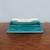 Underside of the rectangular teal glazed ceramic bonsai pot
