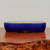 Side view of the rectangular blue glazed pot on a dark wood stand