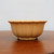 Cream glazed pot with a scalloped rim and lobed flower-shaped body