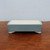 Shallow rectangular pot in matte light blue on weathered wood