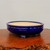 Front view of the glossy cobalt blue pot on a natural wood slab