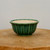 Round forest green pot with a classic fluted scalloped exterior